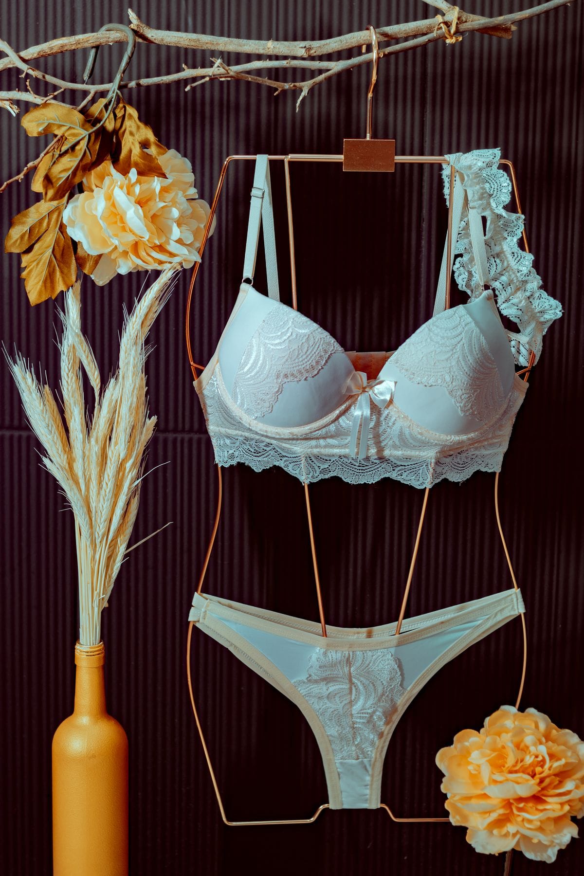 Champagne lace lingerie set on dark editorial backdrop