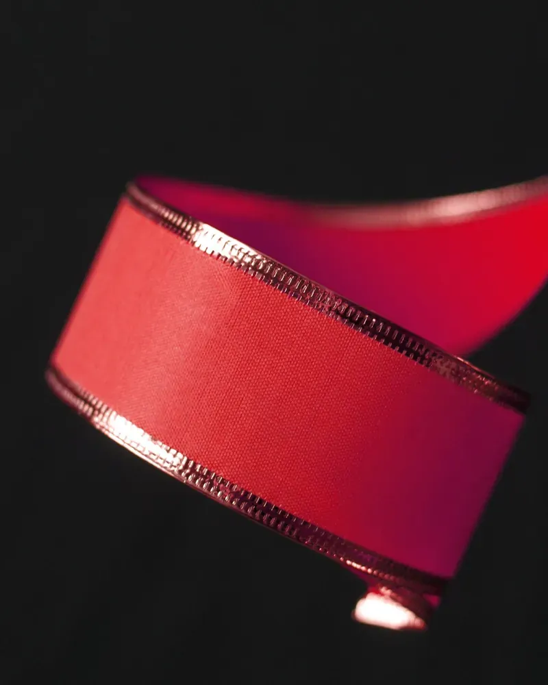 Red satin ribbon on black