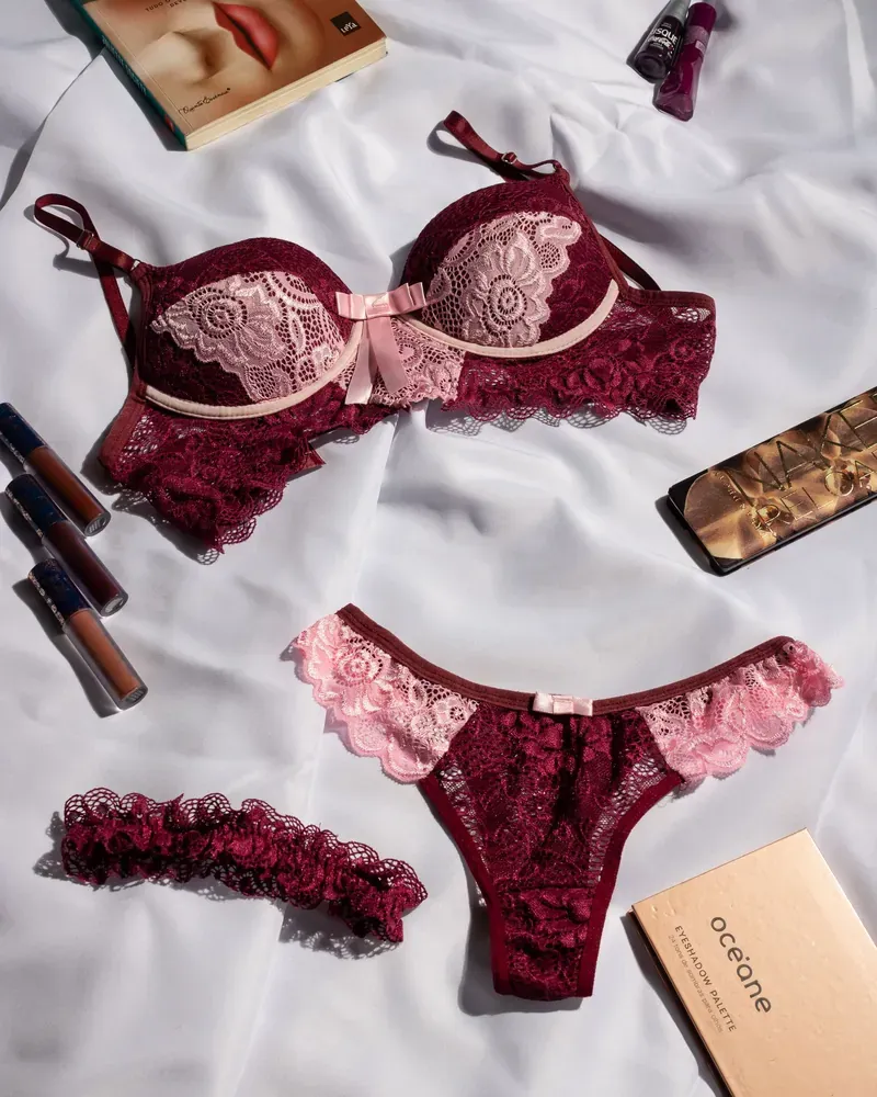 Burgundy lace lingerie set laid flat