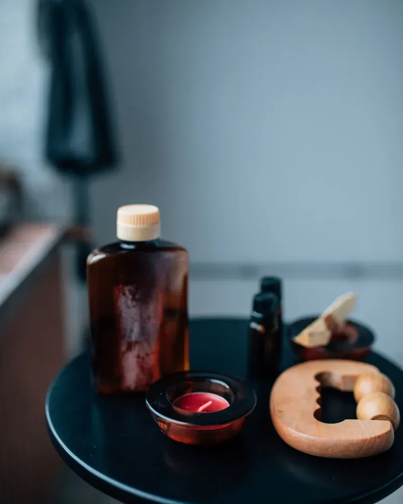 Massage oils and candles on a dark side table