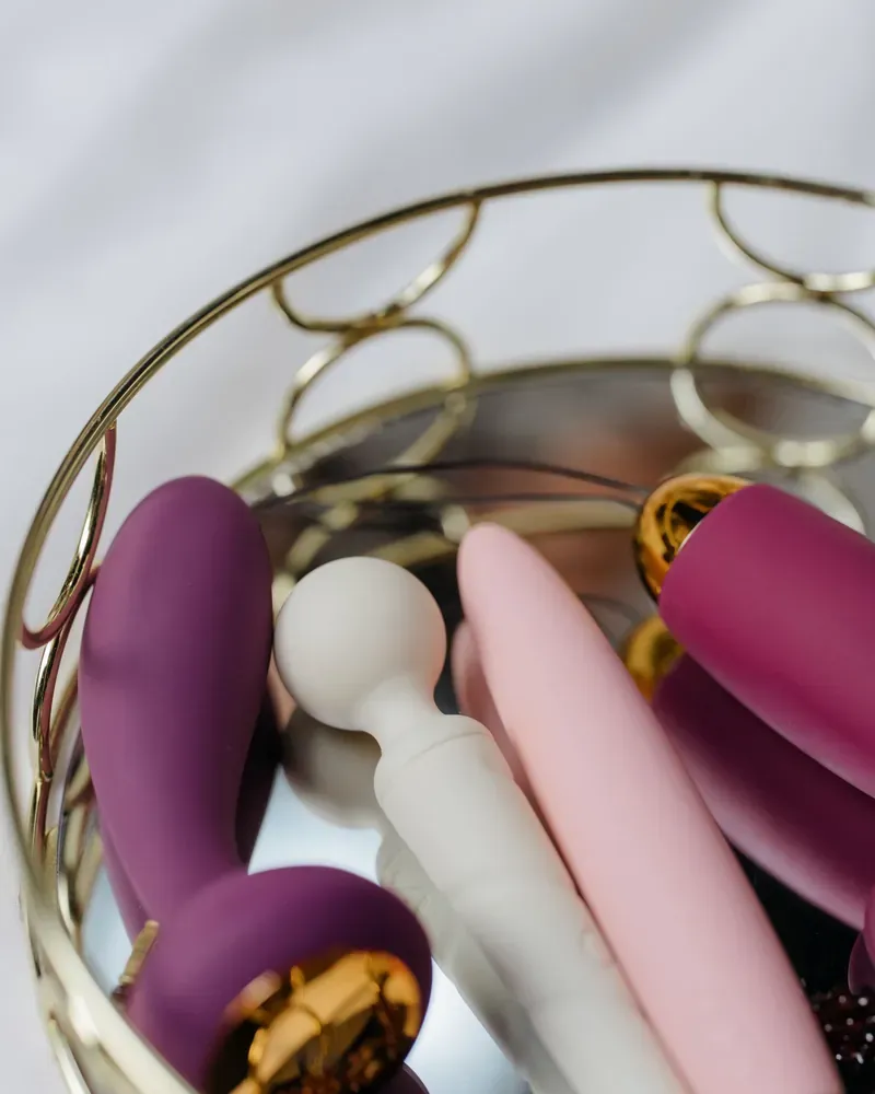 Silicone toys in a gold wire basket